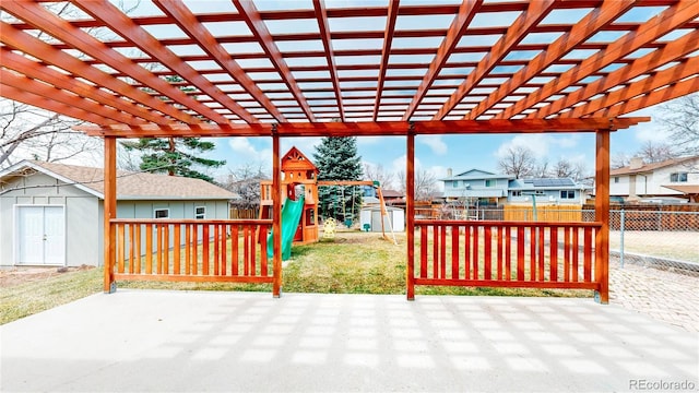 view of patio with a playground, a storage unit, a pergola, a fenced backyard, and an outdoor structure