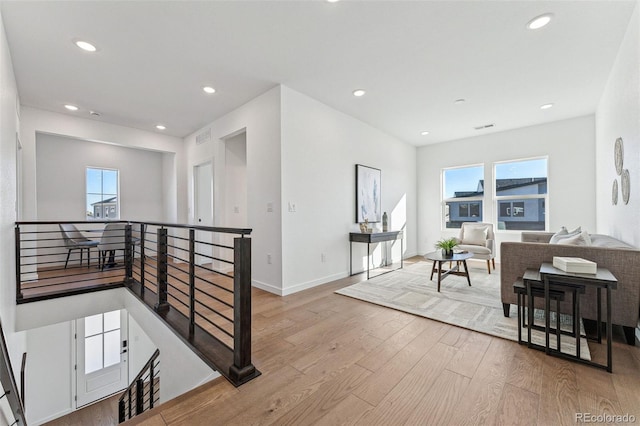 living room featuring plenty of natural light and light hardwood / wood-style floors