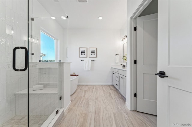 bathroom featuring separate shower and tub and vanity