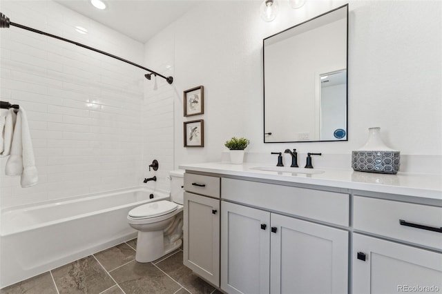 full bathroom with toilet, vanity, and tiled shower / bath