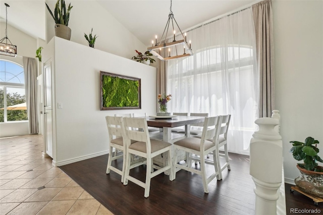 4520 Maroon Cir, Broomfield, CO 80023 - dining space with a chandelier, high vaulted ceiling, and tile patterned flooring