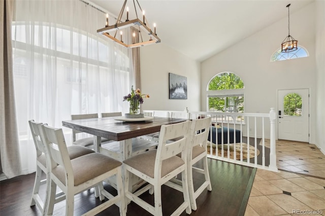 4520 Maroon Cir, Broomfield, CO 80023 - dining space featuring high vaulted ceiling, a chandelier, and light tile patterned floors