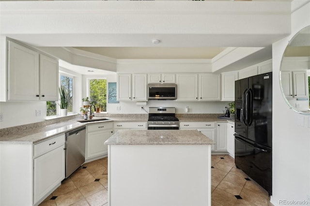 4520 Maroon Cir, Broomfield, CO 80023 - kitchen with stainless steel appliances, a sink, a kitchen island, light tile patterned floors, and white cabinetry