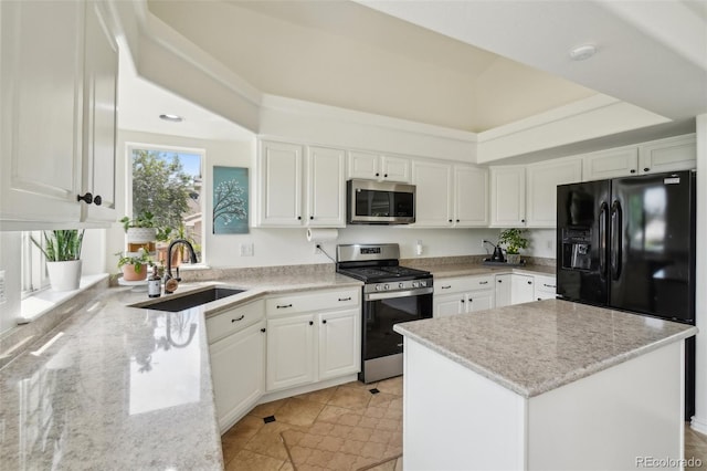 4520 Maroon Cir, Broomfield, CO 80023 - kitchen with appliances with stainless steel finishes, a sink, white cabinets, light stone counters, and a kitchen island