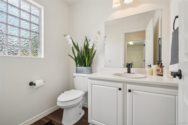 4520 Maroon Cir, Broomfield, CO 80023 - bathroom with toilet, vanity, wood finished floors, and baseboards
