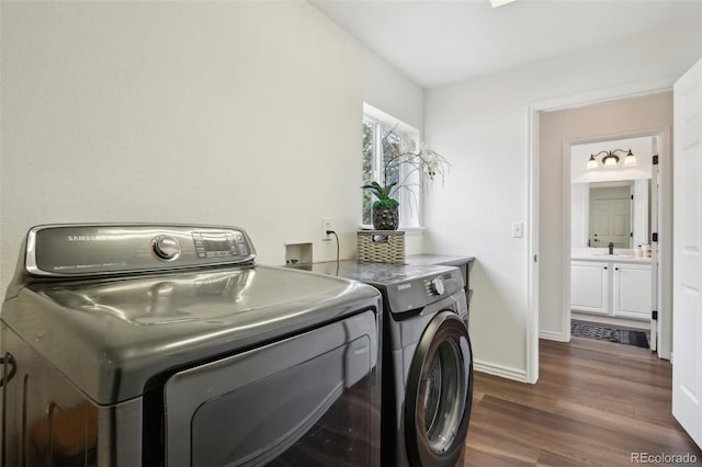 4520 Maroon Cir, Broomfield, CO 80023 - laundry area featuring washing machine and dryer, dark wood finished floors, and baseboards