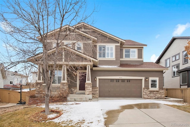 craftsman inspired home featuring a garage, brick siding, driveway, and fence