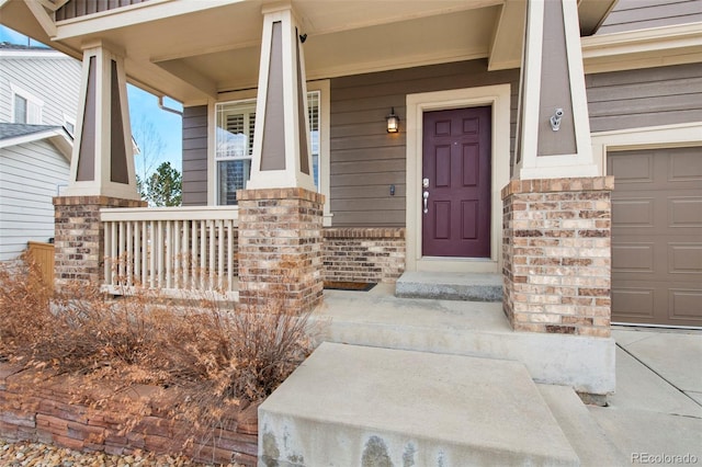 property entrance with covered porch and brick siding