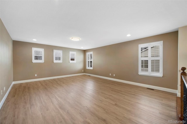 unfurnished room featuring light wood-type flooring and baseboards