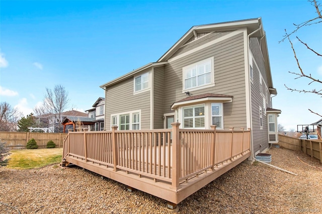 rear view of property with a fenced backyard and a wooden deck