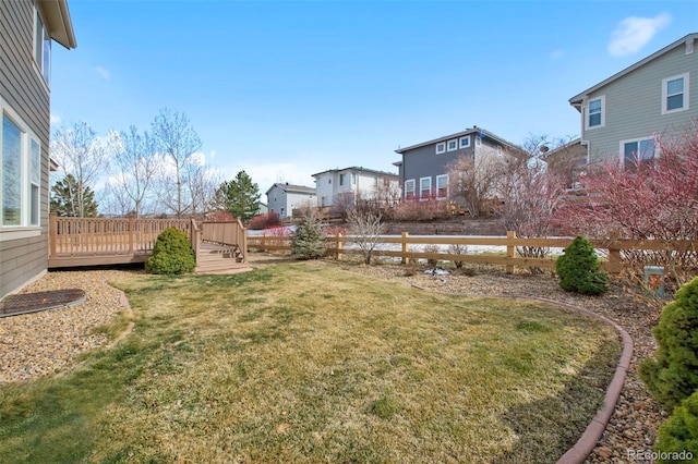 view of yard featuring fence and a deck