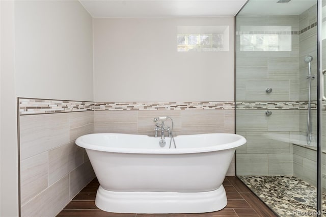 5743 Field St, Arvada, CO 80002 - bathroom with tile walls, a stall shower, a soaking tub, and wainscoting