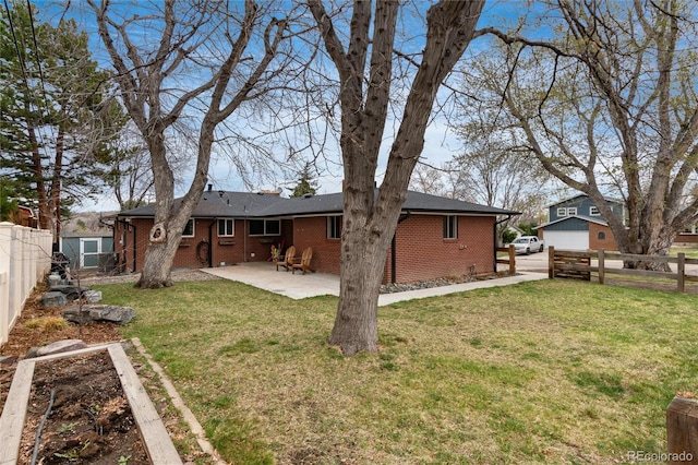 5743 Field St, Arvada, CO 80002 - back of house featuring a patio and brick siding