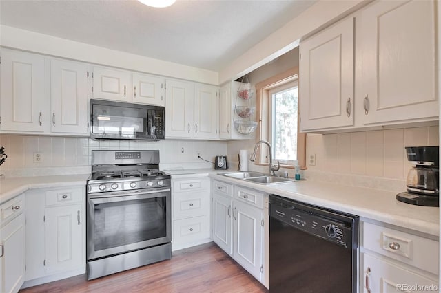10771 Winding Meadow Dr, Kiowa, CO 80117 - kitchen featuring black appliances, white cabinetry, and light countertops