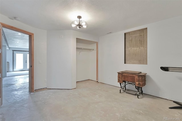 10771 Winding Meadow Dr, Kiowa, CO 80117 - interior space with concrete flooring, a textured ceiling, a chandelier, and visible vents