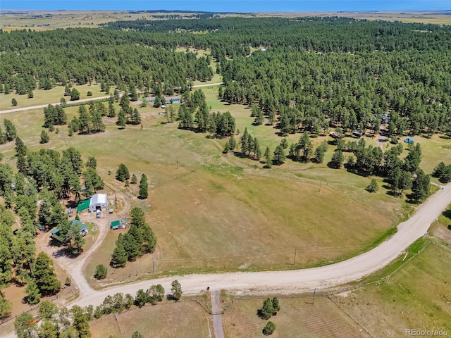 aerial view featuring a rural view and a wooded view