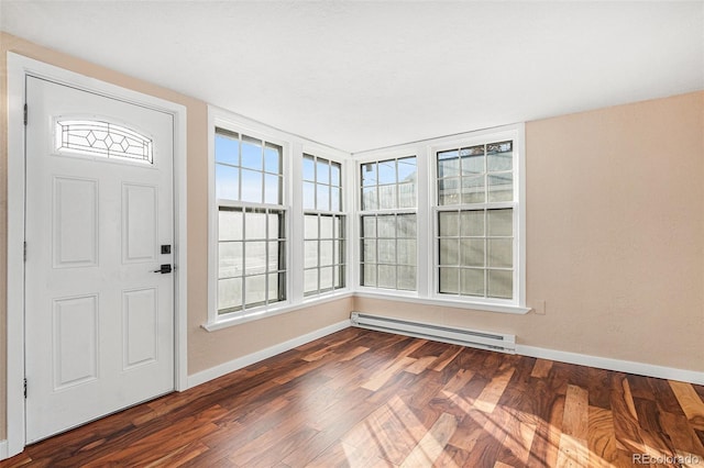 foyer featuring baseboards, a baseboard heating unit, and dark wood finished floors