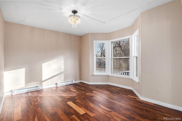 empty room with a baseboard radiator, a notable chandelier, baseboards, and wood finished floors