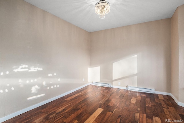 spare room featuring baseboards, a notable chandelier, baseboard heating, and wood finished floors