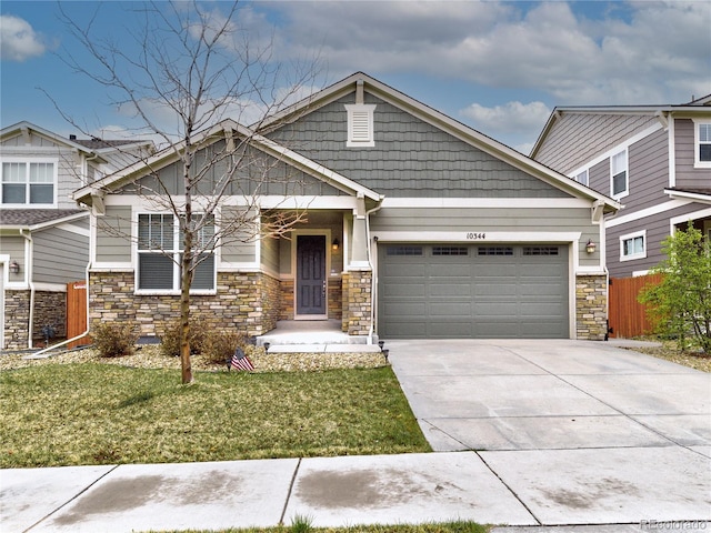 craftsman-style house with driveway, an attached garage, fence, and a front lawn