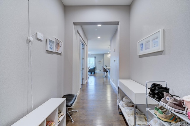 hallway with baseboards and wood finished floors