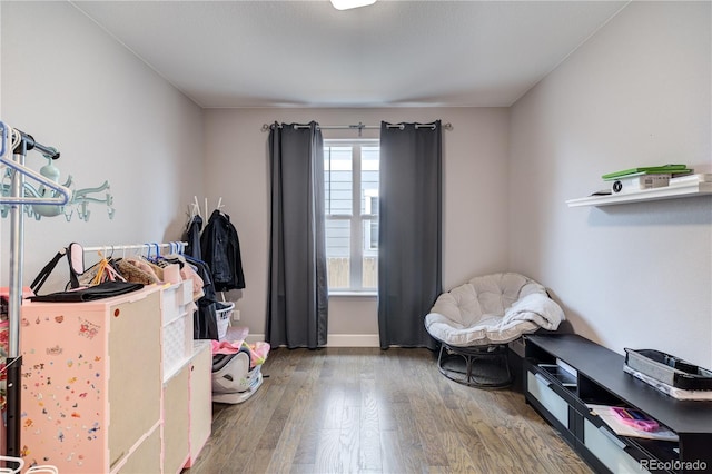 interior space featuring wood finished floors and baseboards