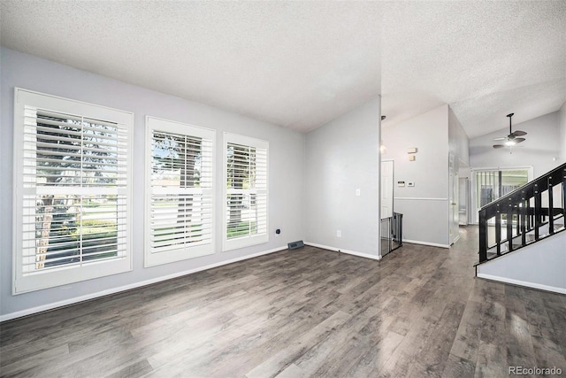 7773 Brentwood Ct, Arvada, CO 80005 - unfurnished living room featuring a textured ceiling, vaulted ceiling, a ceiling fan, wood finished floors, and stairs