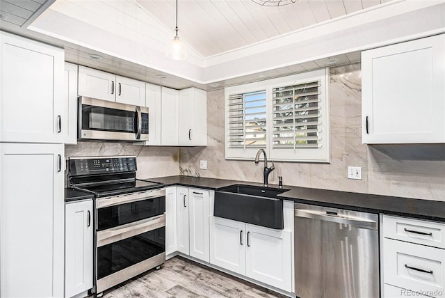 7773 Brentwood Ct, Arvada, CO 80005 - kitchen with appliances with stainless steel finishes, a sink, dark countertops, white cabinets, and wood ceiling