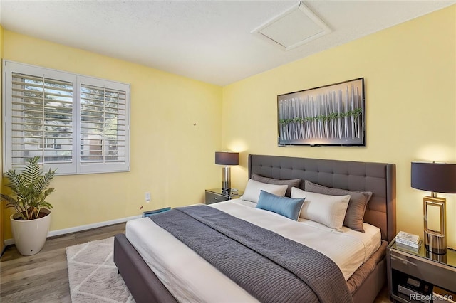 7773 Brentwood Ct, Arvada, CO 80005 - bedroom with wood finished floors, attic access, and baseboards