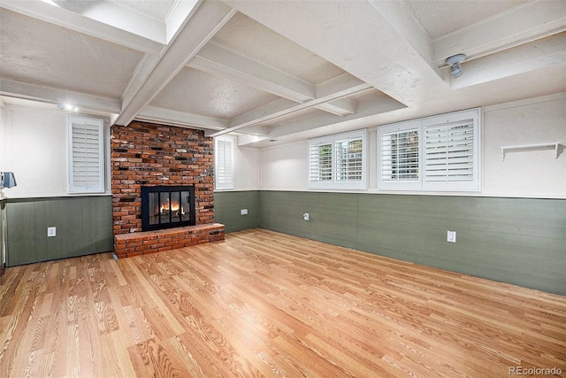 7773 Brentwood Ct, Arvada, CO 80005 - unfurnished living room with wood finished floors, a fireplace, beam ceiling, wainscoting, and wooden walls