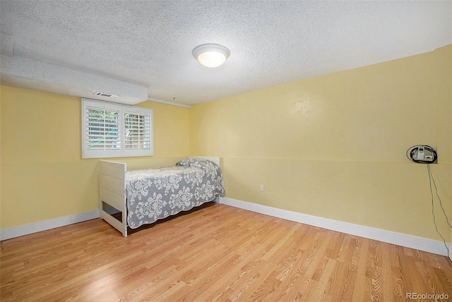 7773 Brentwood Ct, Arvada, CO 80005 - bedroom with wood finished floors, a textured ceiling, and baseboards