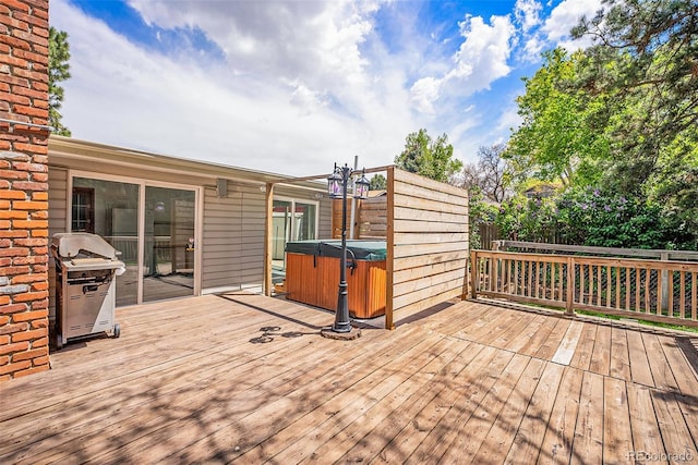 7773 Brentwood Ct, Arvada, CO 80005 - wooden deck with a hot tub, grilling area, and fence