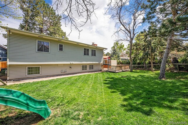 7773 Brentwood Ct, Arvada, CO 80005 - rear view of house featuring a chimney, a playground, and a deck