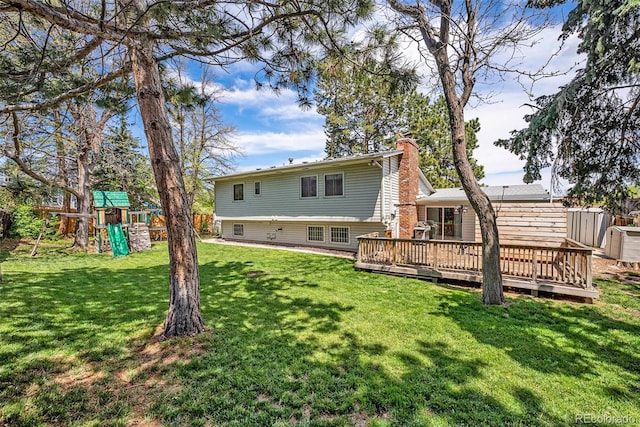 7773 Brentwood Ct, Arvada, CO 80005 - back of house with a playground, a chimney, and a wooden deck