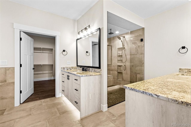 bathroom featuring an enclosed shower and vanity