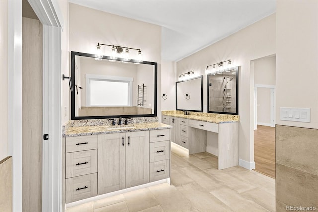 bathroom featuring a shower, tile patterned floors, and vanity