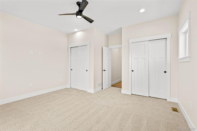 unfurnished bedroom with ceiling fan and light carpet