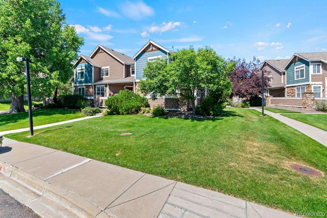 13231 Holly St Unit B, Thornton, CO 80241 - view of front of house featuring a front yard and stone siding