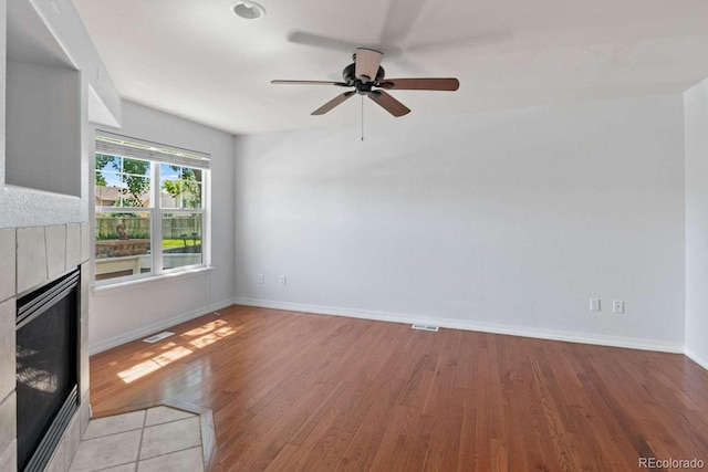 13231 Holly St Unit B, Thornton, CO 80241 - unfurnished living room featuring a fireplace, light wood finished floors, and ceiling fan