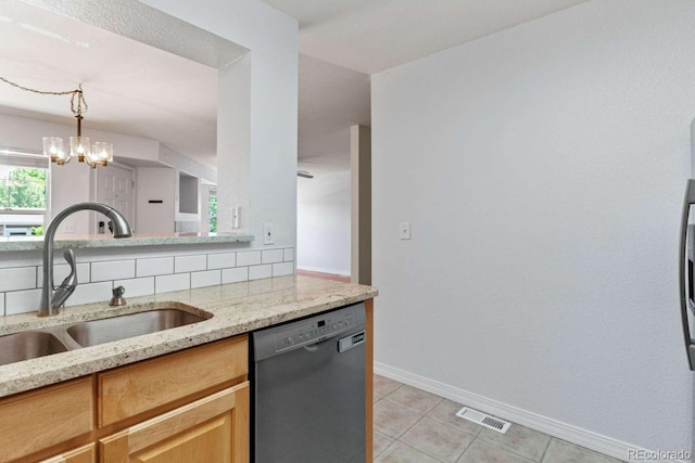 13231 Holly St Unit B, Thornton, CO 80241 - kitchen with dishwashing machine, light stone countertops, light tile patterned floors, a chandelier, and light brown cabinets