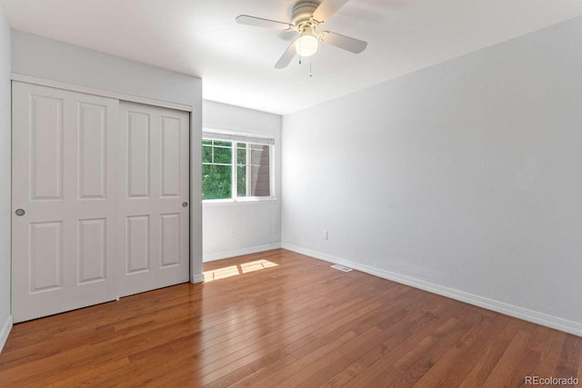 13231 Holly St Unit B, Thornton, CO 80241 - unfurnished bedroom with light wood-style floors, a closet, and a ceiling fan