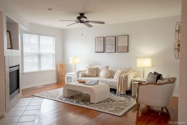 13231 Holly St Unit B, Thornton, CO 80241 - living area with a fireplace, a ceiling fan, and light wood-style floors