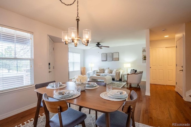 13231 Holly St Unit B, Thornton, CO 80241 - dining area with a chandelier, ceiling fan, and light wood-style flooring