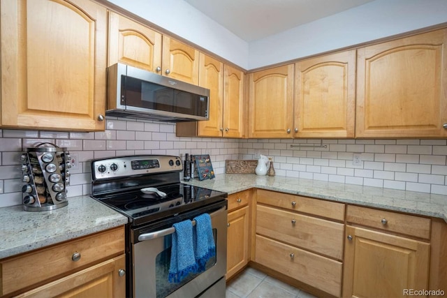 13231 Holly St Unit B, Thornton, CO 80241 - kitchen with appliances with stainless steel finishes, light stone counters, and tasteful backsplash