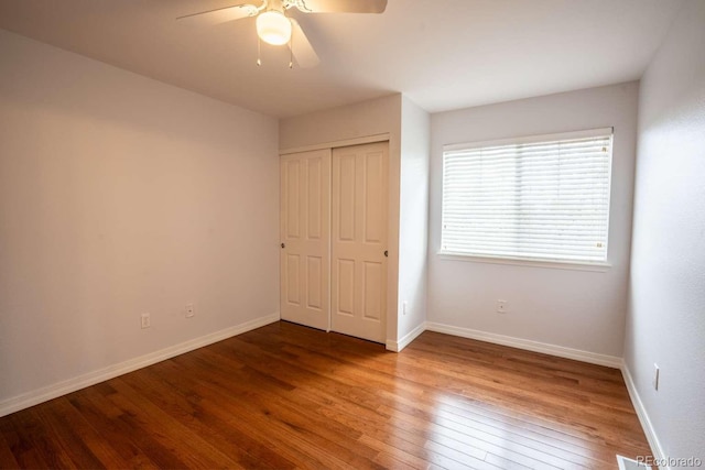 13231 Holly St Unit B, Thornton, CO 80241 - unfurnished bedroom featuring hardwood / wood-style flooring, a closet, and a ceiling fan