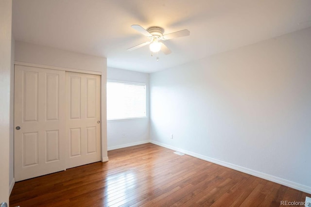 13231 Holly St Unit B, Thornton, CO 80241 - unfurnished bedroom featuring wood finished floors, a closet, and a ceiling fan