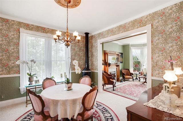 220 E Eaton Ave, Cripple Creek, CO 80813 - dining area featuring wallpapered walls, a chandelier, carpet floors, crown molding, and baseboards