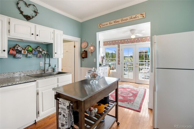 220 E Eaton Ave, Cripple Creek, CO 80813 - kitchen featuring white appliances, a sink, white cabinets, light wood-style flooring, and french doors