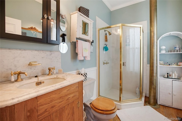 220 E Eaton Ave, Cripple Creek, CO 80813 - full bathroom featuring toilet, a shower stall, vanity, and ornamental molding