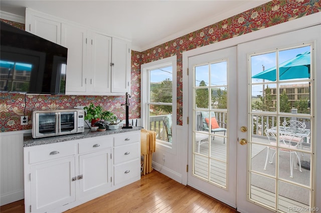 220 E Eaton Ave, Cripple Creek, CO 80813 - doorway to outside with wallpapered walls and light wood-style flooring